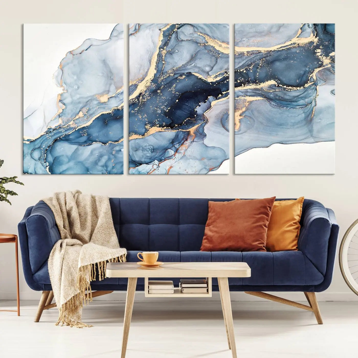 The living room showcases a striking Abstract Art Print - Blue Abstract Canvas Wall Art, featuring fluid effect artwork in vibrant blue and gold tones.