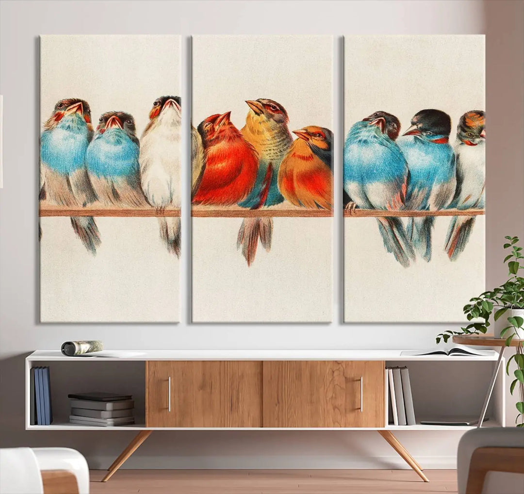 The Abstract Birds Wall Art Canvas Print, featuring a triptych of colorful birds perched on a branch, is printed on museum-quality canvas and equipped with a UV-protective coating and ready-to-hang design. This artwork adds vibrant elegance to your living space.