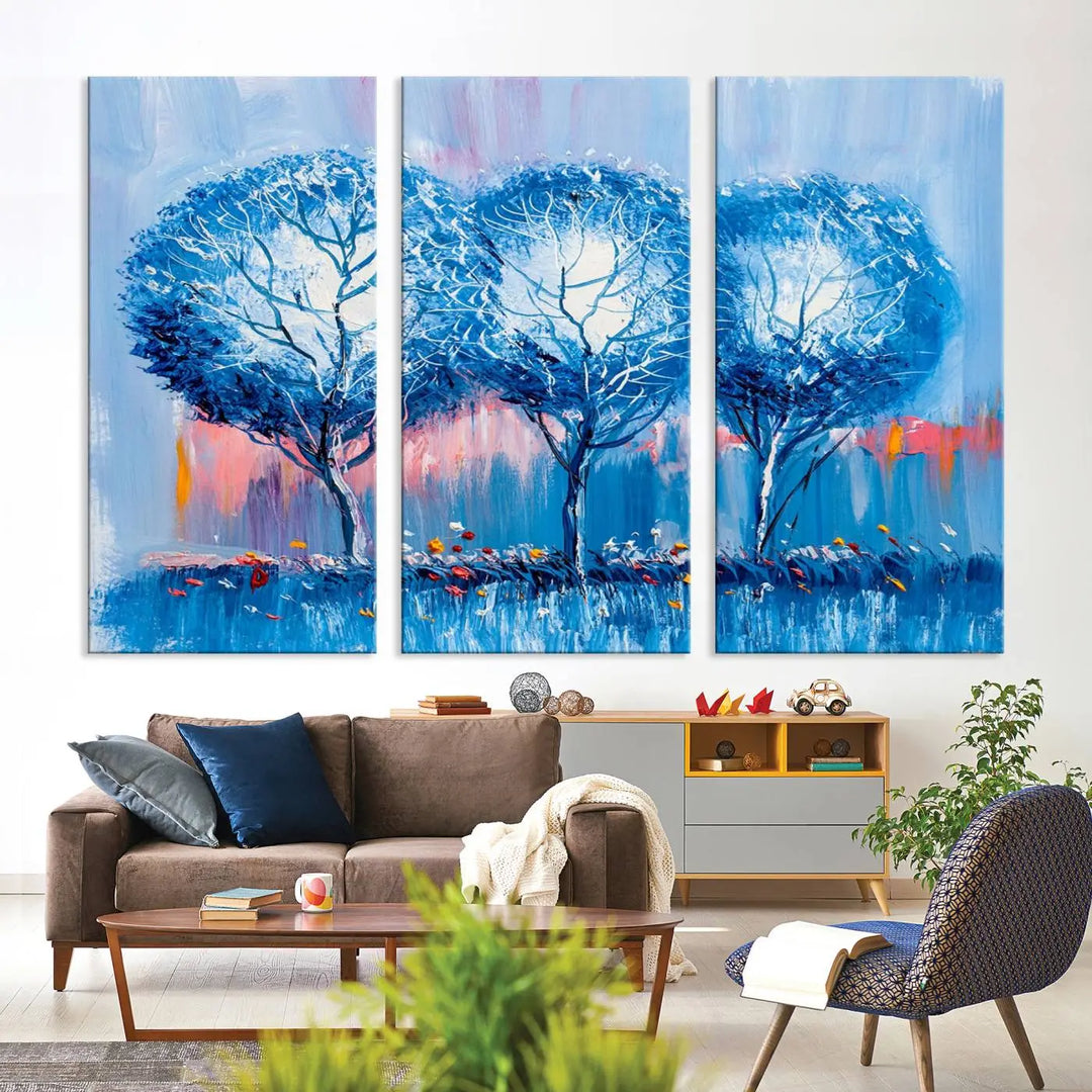 The living room showcases the Abstract Blue Trees Trendy Wall Art Canvas Print, elegantly featuring a triptych of blue trees against a pink background.