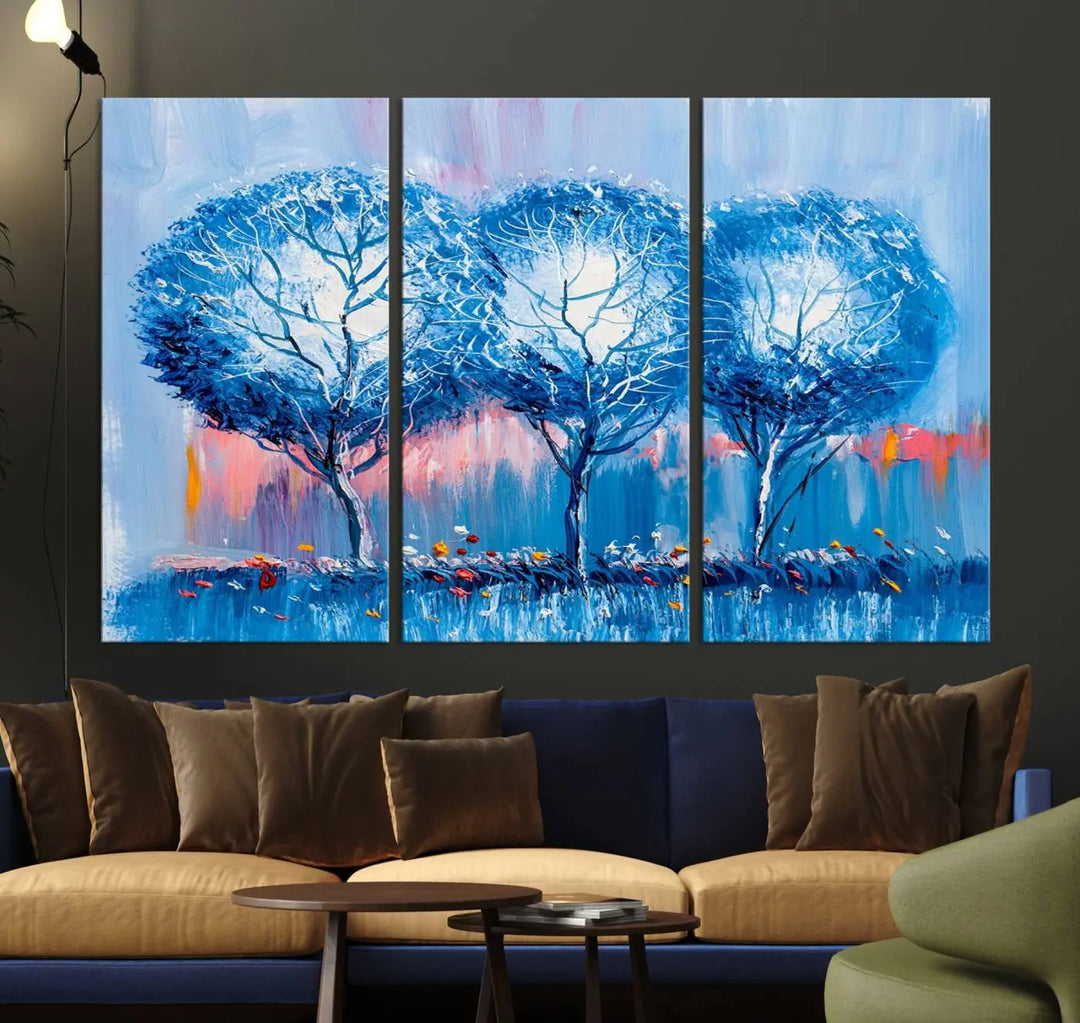 The living room showcases the Abstract Blue Trees Trendy Wall Art Canvas Print, elegantly featuring a triptych of blue trees against a pink background.