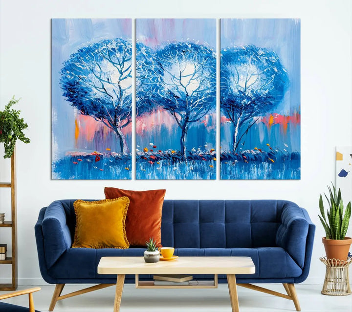 The living room showcases the Abstract Blue Trees Trendy Wall Art Canvas Print, elegantly featuring a triptych of blue trees against a pink background.