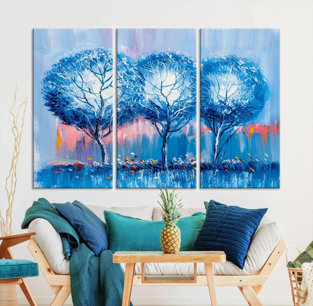 The living room showcases the Abstract Blue Trees Trendy Wall Art Canvas Print, elegantly featuring a triptych of blue trees against a pink background.