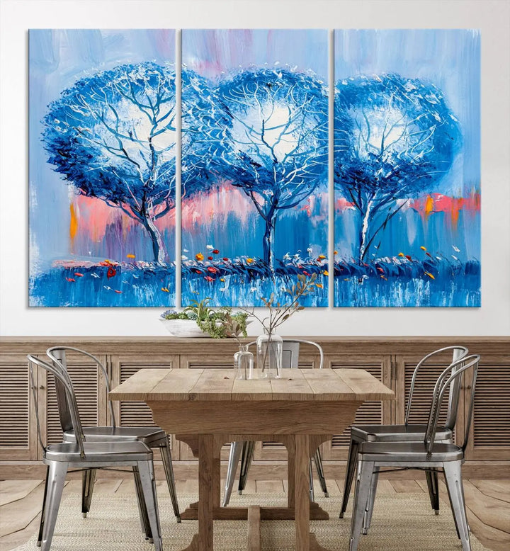 The living room showcases the Abstract Blue Trees Trendy Wall Art Canvas Print, elegantly featuring a triptych of blue trees against a pink background.