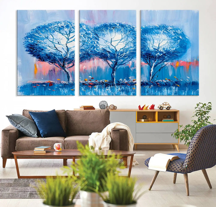 The living room showcases the Abstract Blue Trees Trendy Wall Art Canvas Print, elegantly featuring a triptych of blue trees against a pink background.