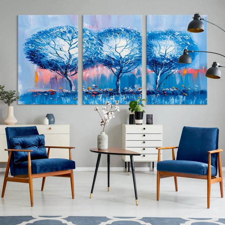 The living room showcases the Abstract Blue Trees Trendy Wall Art Canvas Print, elegantly featuring a triptych of blue trees against a pink background.