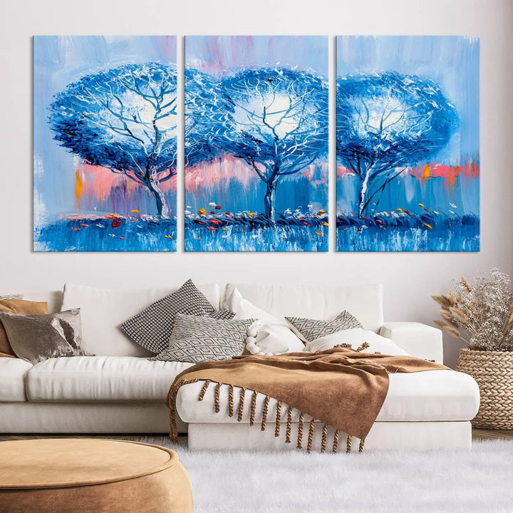 The living room showcases the Abstract Blue Trees Trendy Wall Art Canvas Print, elegantly featuring a triptych of blue trees against a pink background.