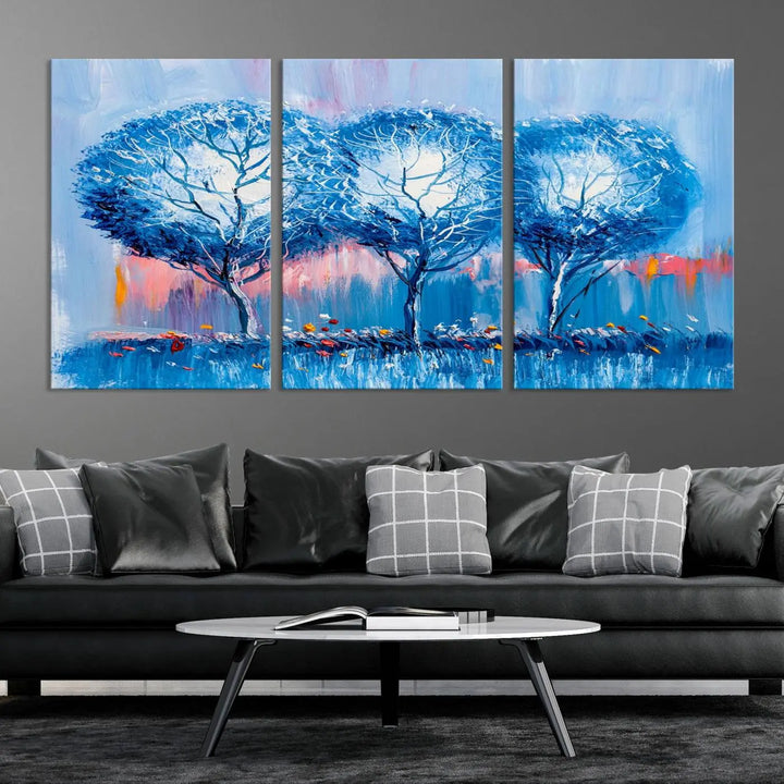 The living room showcases the Abstract Blue Trees Trendy Wall Art Canvas Print, elegantly featuring a triptych of blue trees against a pink background.