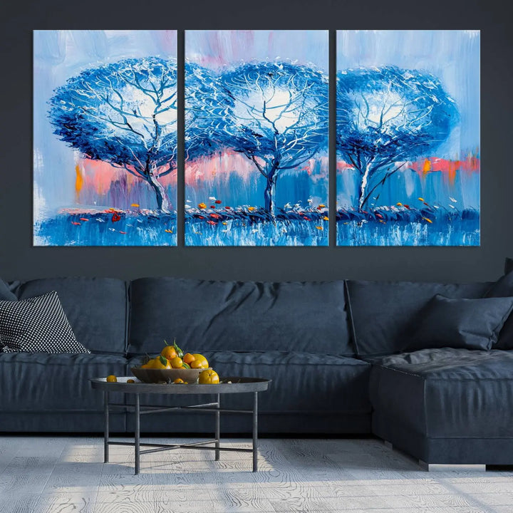 The living room showcases the Abstract Blue Trees Trendy Wall Art Canvas Print, elegantly featuring a triptych of blue trees against a pink background.