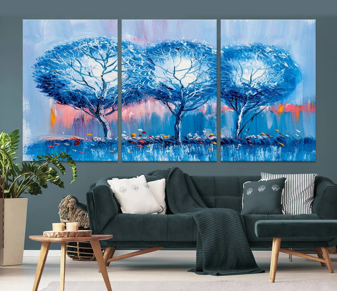 The living room showcases the Abstract Blue Trees Trendy Wall Art Canvas Print, elegantly featuring a triptych of blue trees against a pink background.