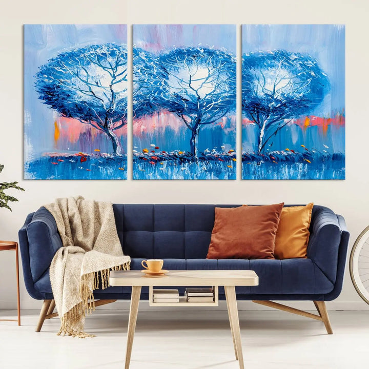 The living room showcases the Abstract Blue Trees Trendy Wall Art Canvas Print, elegantly featuring a triptych of blue trees against a pink background.