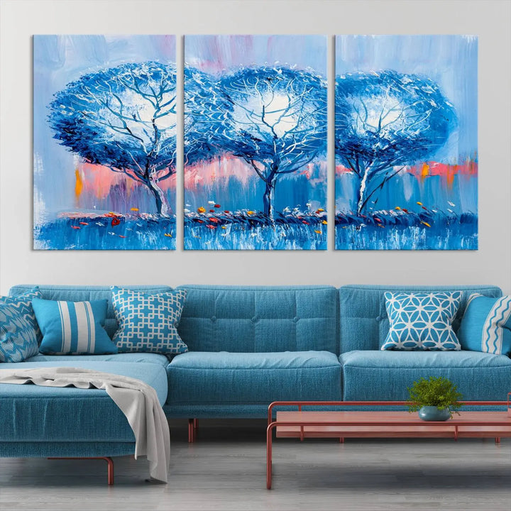 The living room showcases the Abstract Blue Trees Trendy Wall Art Canvas Print, elegantly featuring a triptych of blue trees against a pink background.