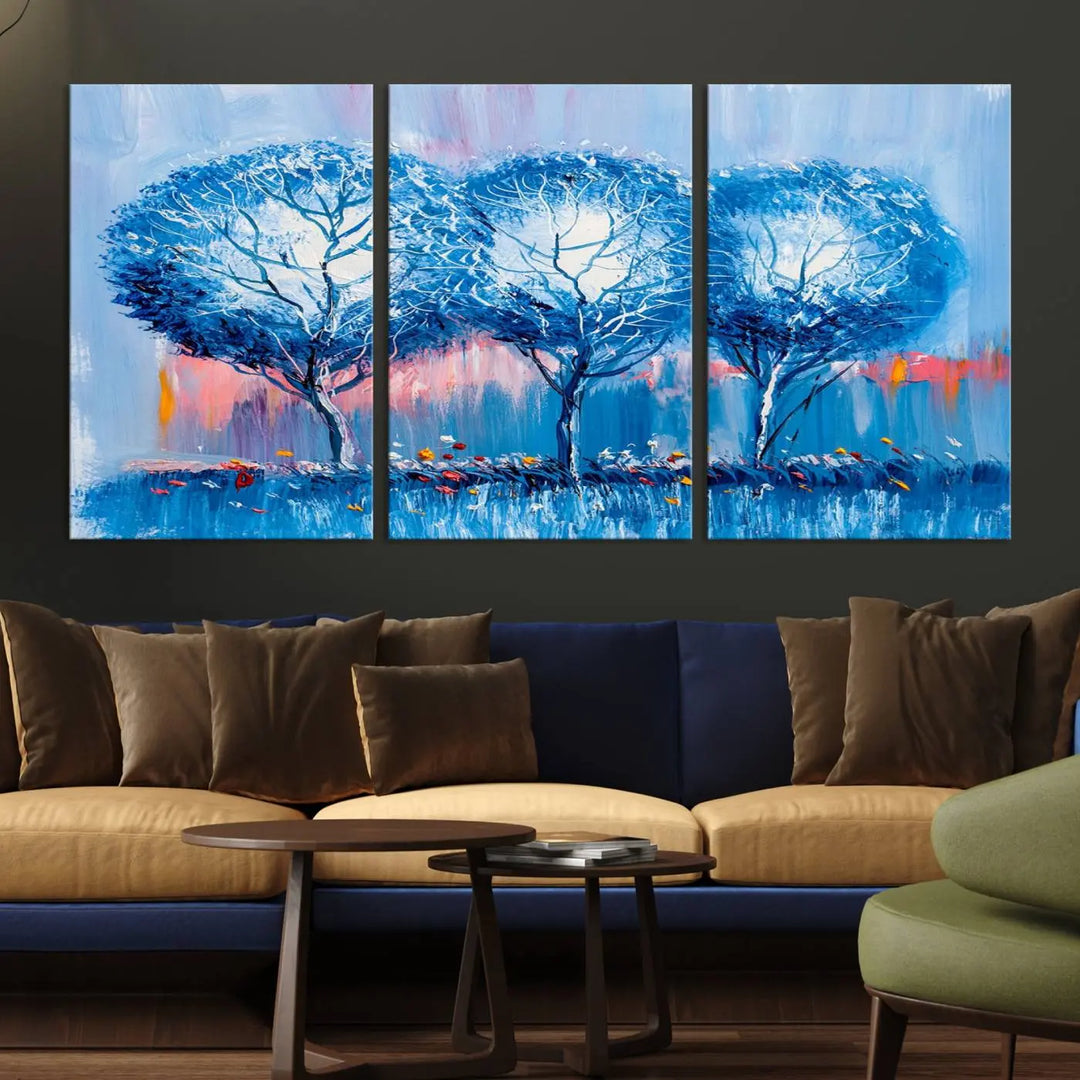 The living room showcases the Abstract Blue Trees Trendy Wall Art Canvas Print, elegantly featuring a triptych of blue trees against a pink background.