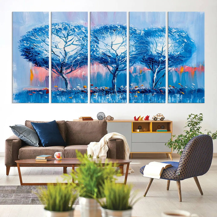 The living room showcases the Abstract Blue Trees Trendy Wall Art Canvas Print, elegantly featuring a triptych of blue trees against a pink background.