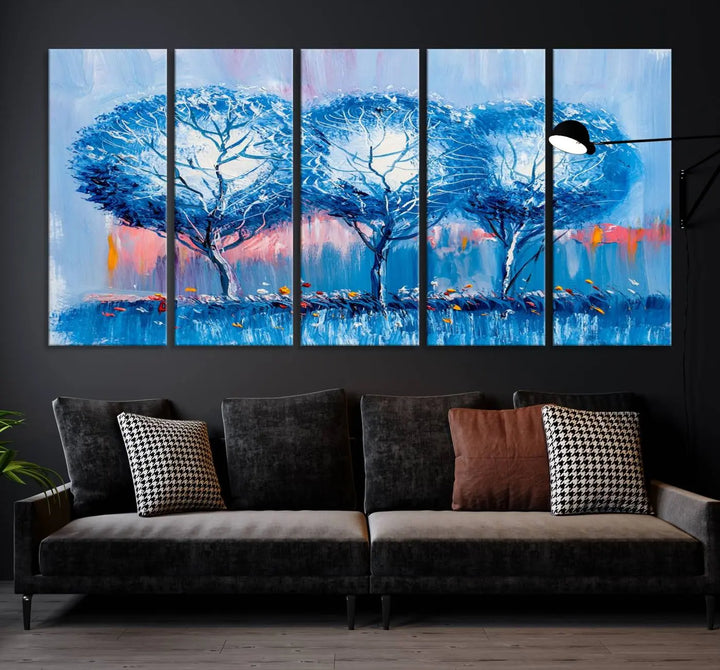 The living room showcases the Abstract Blue Trees Trendy Wall Art Canvas Print, elegantly featuring a triptych of blue trees against a pink background.