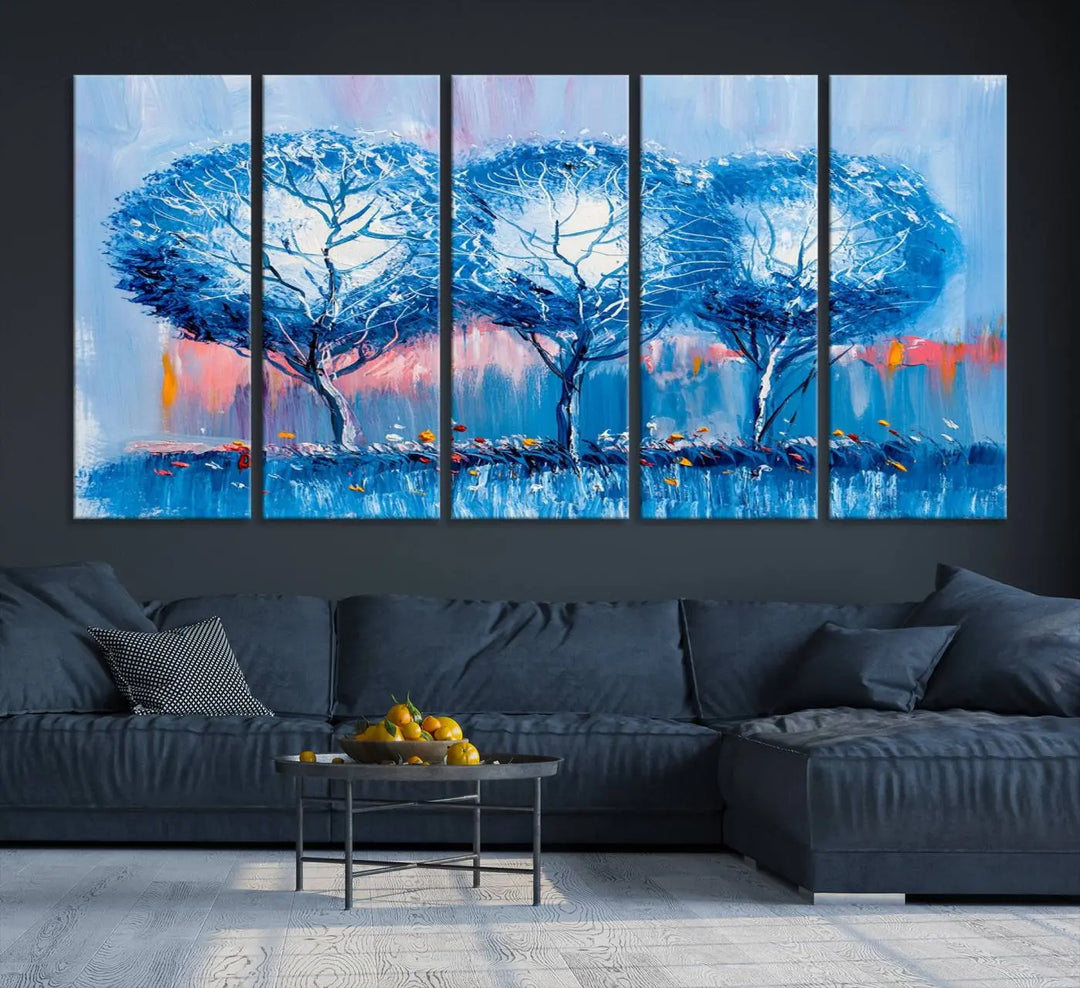 The living room showcases the Abstract Blue Trees Trendy Wall Art Canvas Print, elegantly featuring a triptych of blue trees against a pink background.