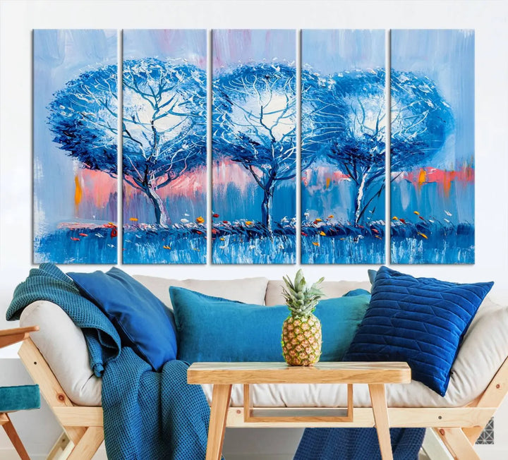 The living room showcases the Abstract Blue Trees Trendy Wall Art Canvas Print, elegantly featuring a triptych of blue trees against a pink background.