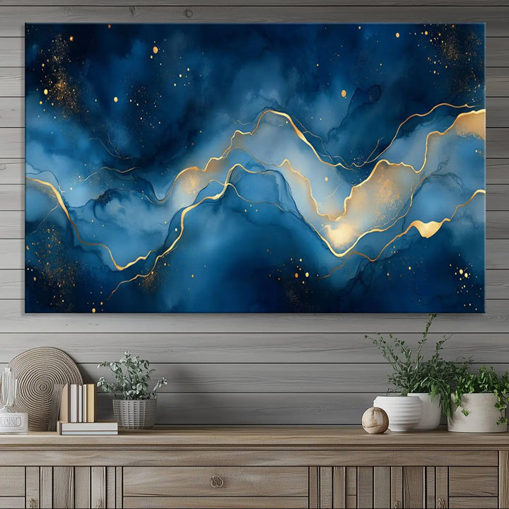 The gallery-quality Abstract Blue and Gold Canvas Wall Art hangs prominently on the wall.