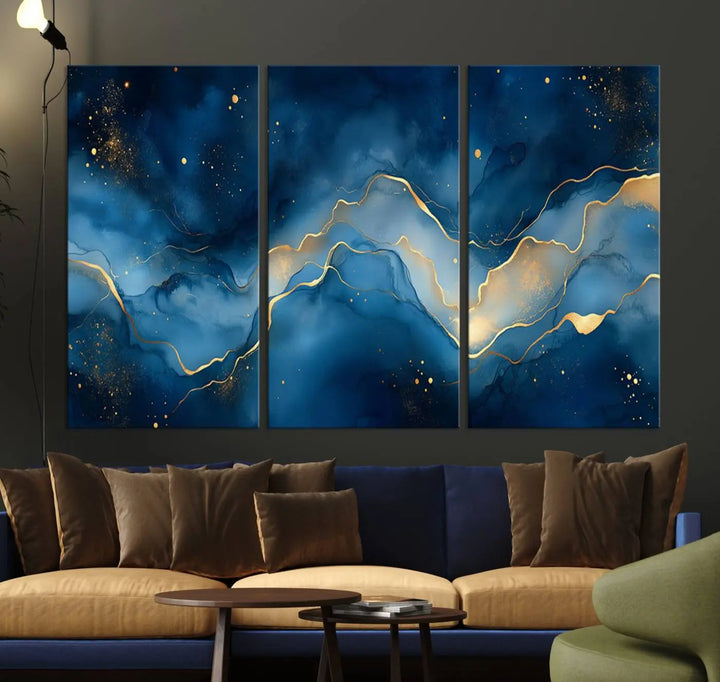 The gallery-quality Abstract Blue and Gold Canvas Wall Art hangs prominently on the wall.