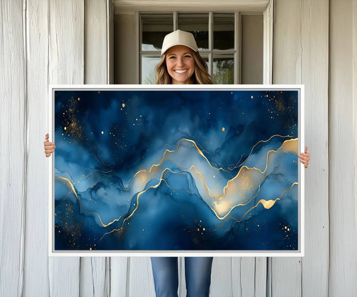 The gallery-quality Abstract Blue and Gold Canvas Wall Art hangs prominently on the wall.