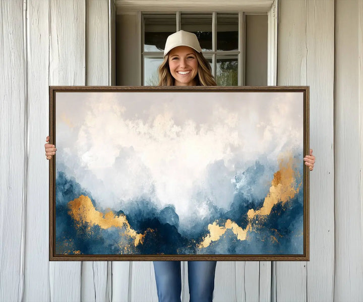 The Abstract Blue and Gold Clouds canvas art enhances the space.