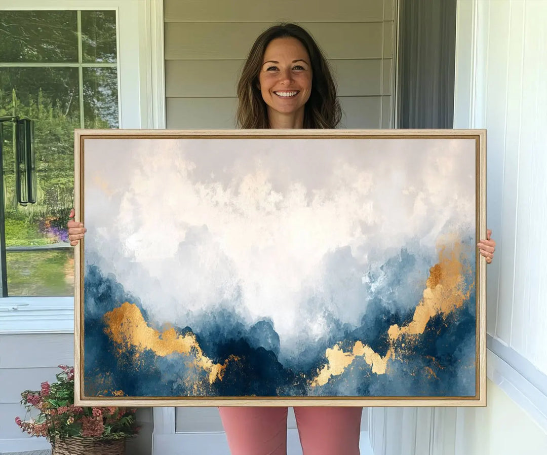 The Abstract Blue and Gold Clouds canvas art enhances the space.