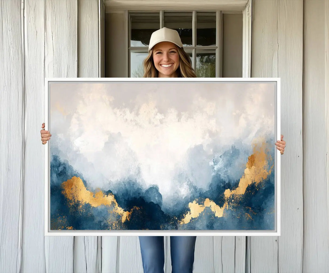 The Abstract Blue and Gold Clouds canvas art enhances the space.