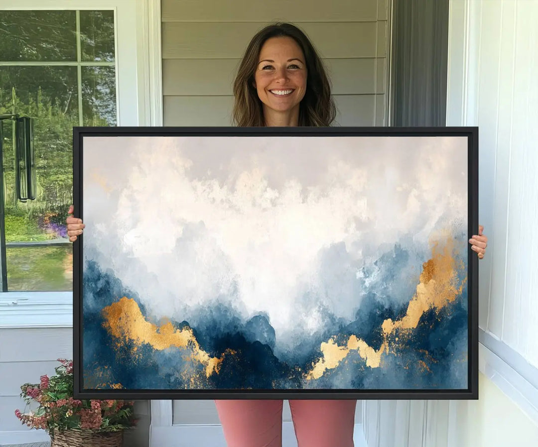 The Abstract Blue and Gold Clouds canvas art enhances the space.