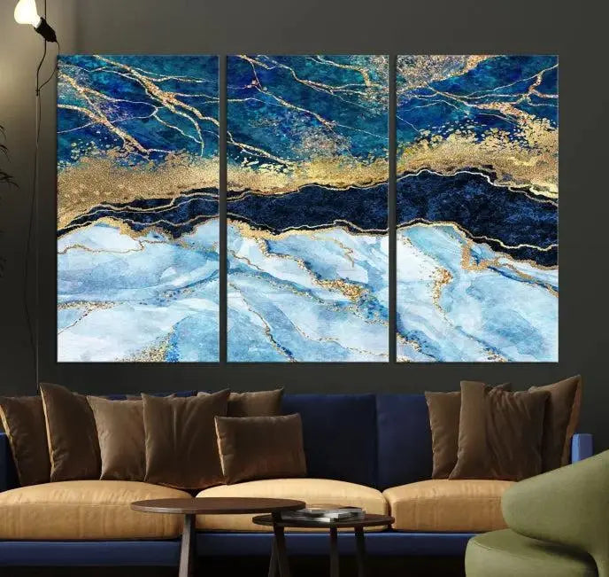 The room features a captivating Abstract Blue and Gold Marble Canvas Print displayed as a large 3-panel wall decor, infusing the space with modern elegance.