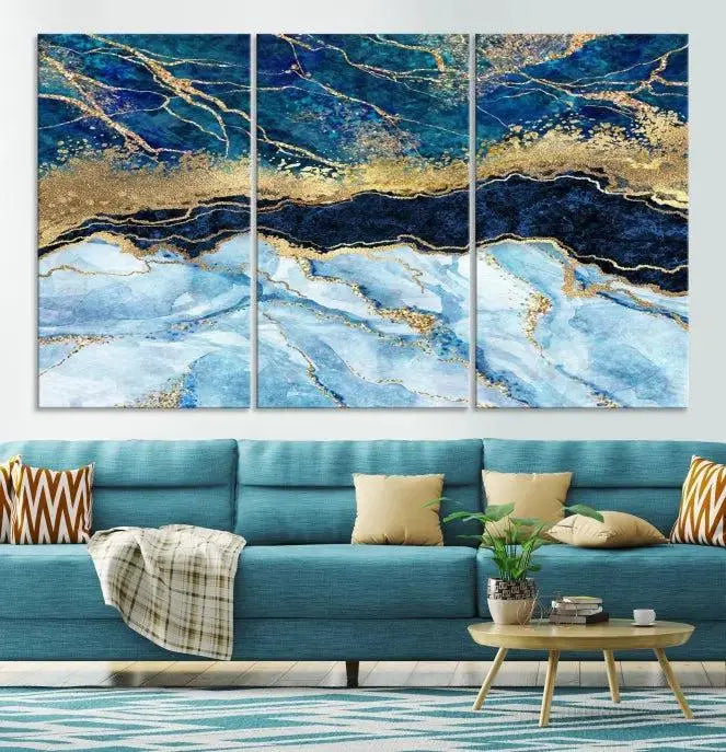 The room features a captivating Abstract Blue and Gold Marble Canvas Print displayed as a large 3-panel wall decor, infusing the space with modern elegance.