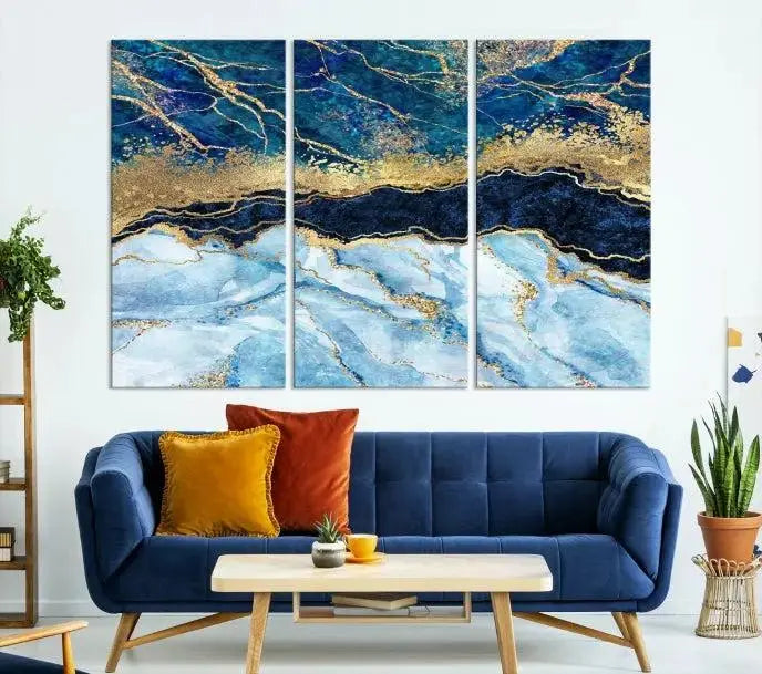 The room features a captivating Abstract Blue and Gold Marble Canvas Print displayed as a large 3-panel wall decor, infusing the space with modern elegance.