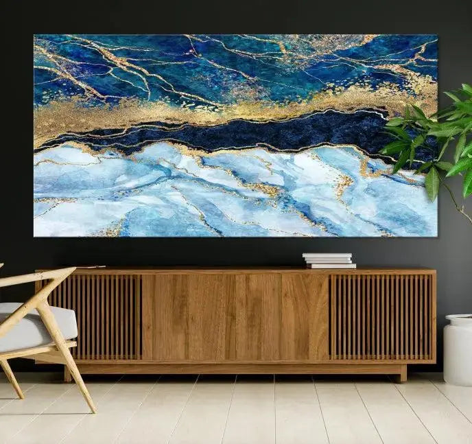 The room features a captivating Abstract Blue and Gold Marble Canvas Print displayed as a large 3-panel wall decor, infusing the space with modern elegance.