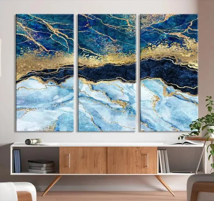 The room features a captivating Abstract Blue and Gold Marble Canvas Print displayed as a large 3-panel wall decor, infusing the space with modern elegance.