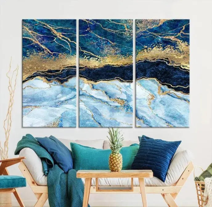 The room features a captivating Abstract Blue and Gold Marble Canvas Print displayed as a large 3-panel wall decor, infusing the space with modern elegance.