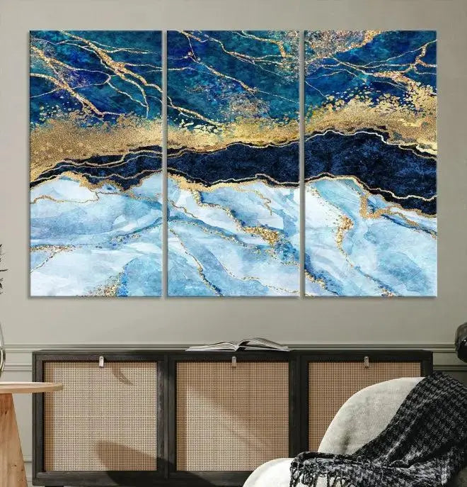 The room features a captivating Abstract Blue and Gold Marble Canvas Print displayed as a large 3-panel wall decor, infusing the space with modern elegance.