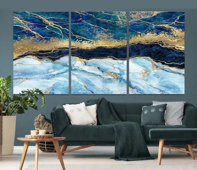 The room features a captivating Abstract Blue and Gold Marble Canvas Print displayed as a large 3-panel wall decor, infusing the space with modern elegance.