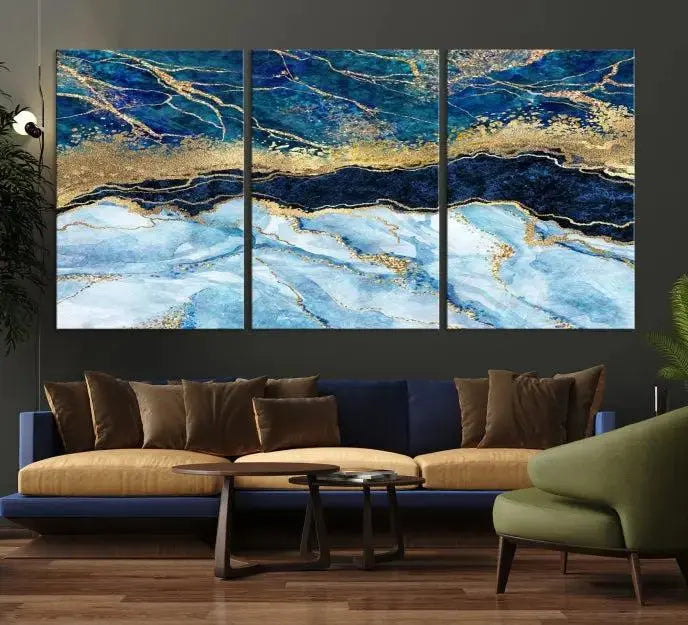 The room features a captivating Abstract Blue and Gold Marble Canvas Print displayed as a large 3-panel wall decor, infusing the space with modern elegance.