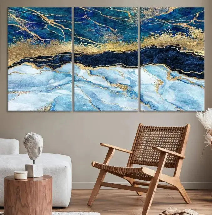 The room features a captivating Abstract Blue and Gold Marble Canvas Print displayed as a large 3-panel wall decor, infusing the space with modern elegance.