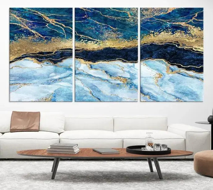 The room features a captivating Abstract Blue and Gold Marble Canvas Print displayed as a large 3-panel wall decor, infusing the space with modern elegance.