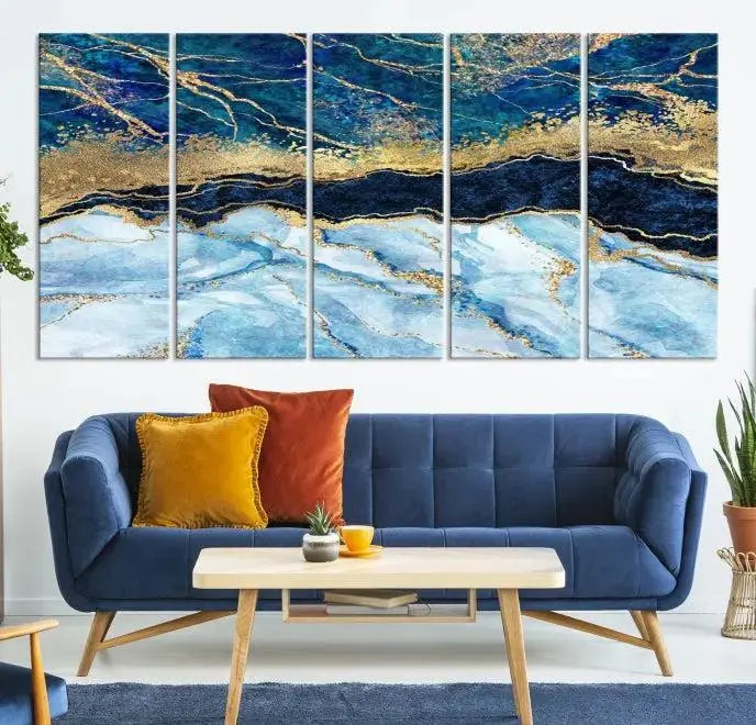 The room features a captivating Abstract Blue and Gold Marble Canvas Print displayed as a large 3-panel wall decor, infusing the space with modern elegance.