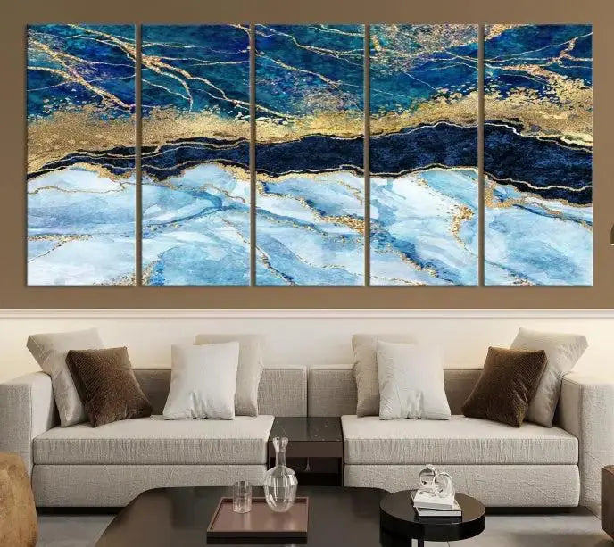 The room features a captivating Abstract Blue and Gold Marble Canvas Print displayed as a large 3-panel wall decor, infusing the space with modern elegance.