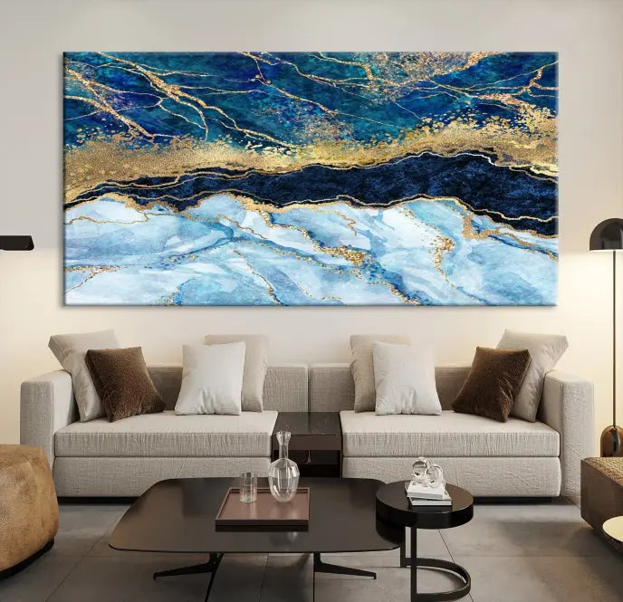 The room features a captivating Abstract Blue and Gold Marble Canvas Print displayed as a large 3-panel wall decor, infusing the space with modern elegance.