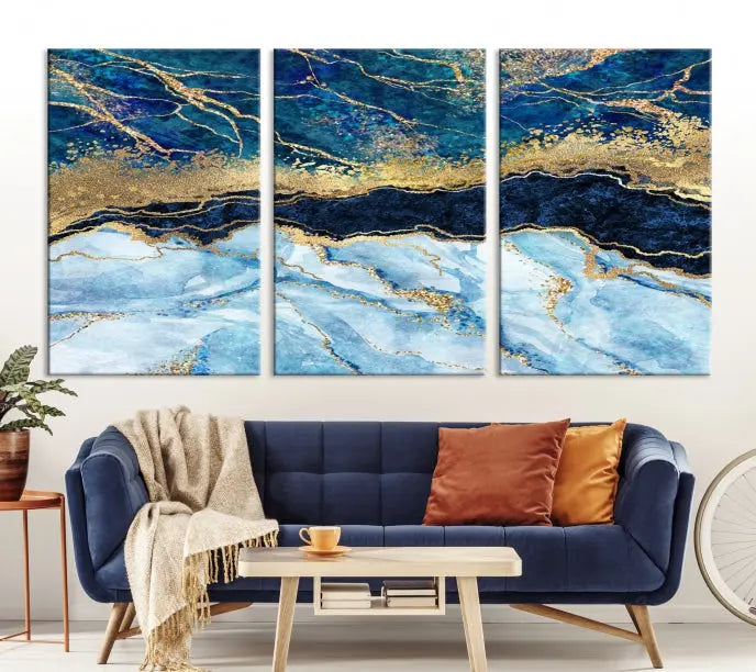 The room features a captivating Abstract Blue and Gold Marble Canvas Print displayed as a large 3-panel wall decor, infusing the space with modern elegance.