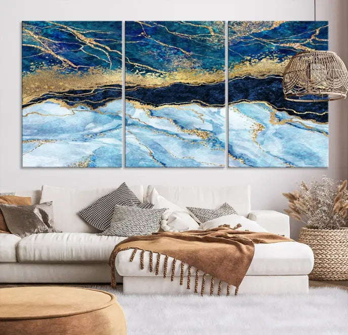 The room features a captivating Abstract Blue and Gold Marble Canvas Print displayed as a large 3-panel wall decor, infusing the space with modern elegance.