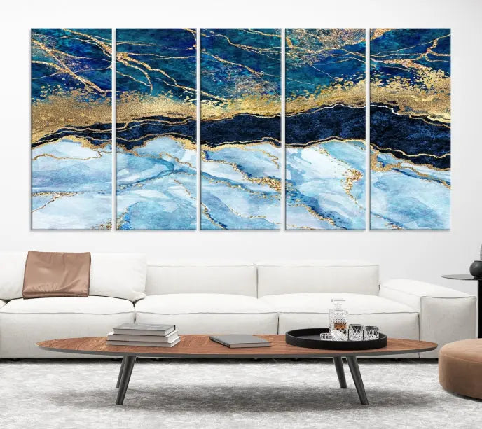 The room features a captivating Abstract Blue and Gold Marble Canvas Print displayed as a large 3-panel wall decor, infusing the space with modern elegance.