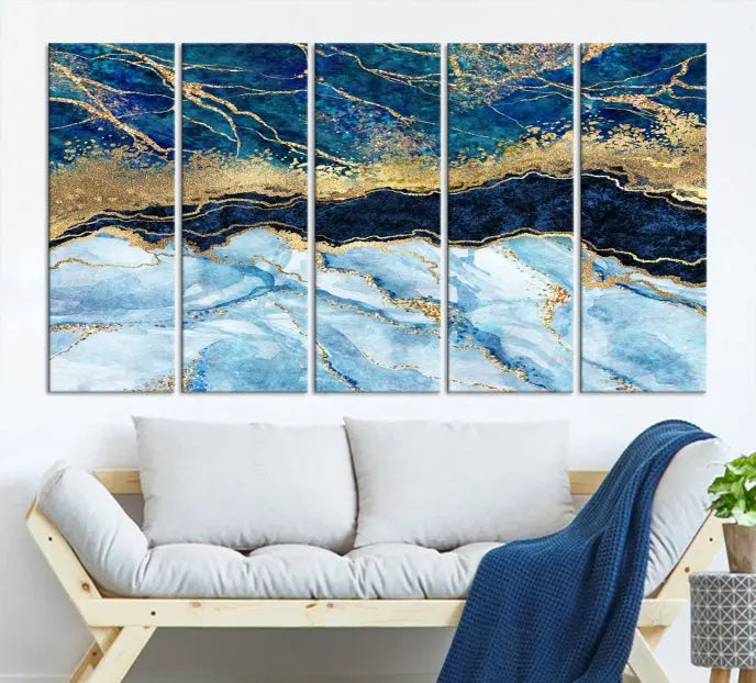 The room features a captivating Abstract Blue and Gold Marble Canvas Print displayed as a large 3-panel wall decor, infusing the space with modern elegance.