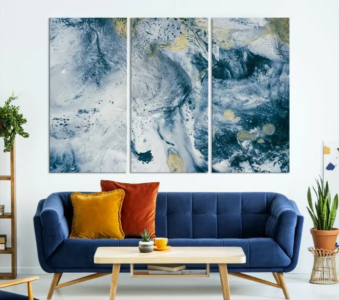 A modern living room features an Abstract Canvas Print as triptych artwork on the wall, elegantly showcased for enduring vibrancy.