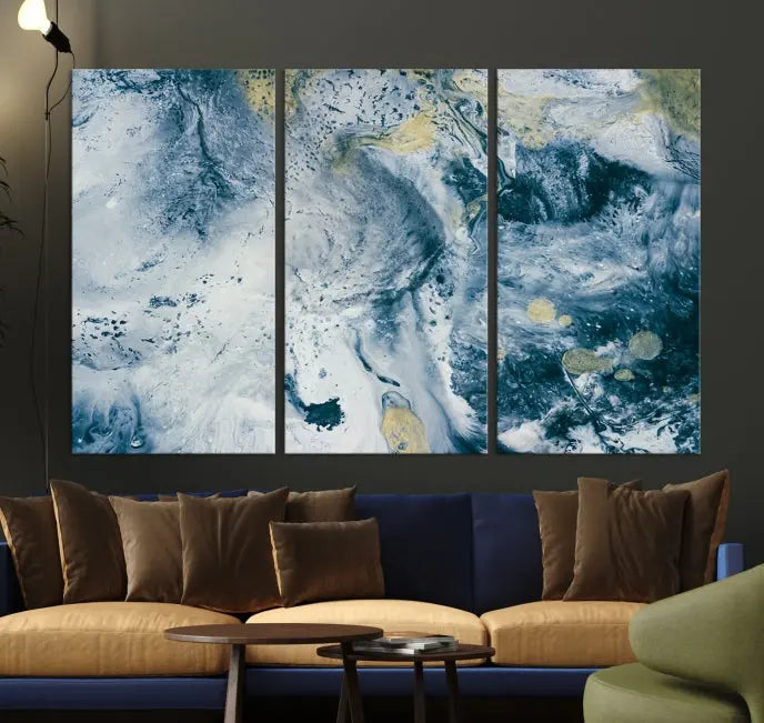 A modern living room features an Abstract Canvas Print as triptych artwork on the wall, elegantly showcased for enduring vibrancy.