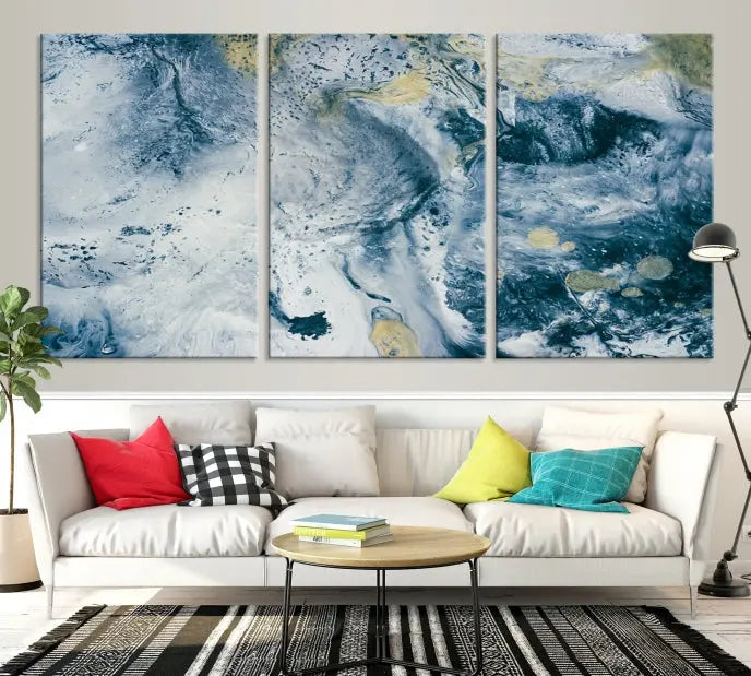 A modern living room features an Abstract Canvas Print as triptych artwork on the wall, elegantly showcased for enduring vibrancy.