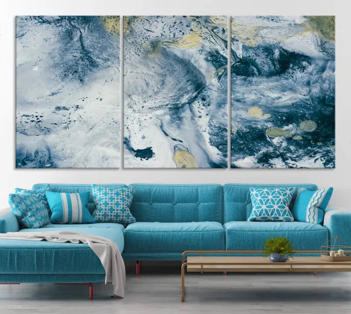 A modern living room features an Abstract Canvas Print as triptych artwork on the wall, elegantly showcased for enduring vibrancy.