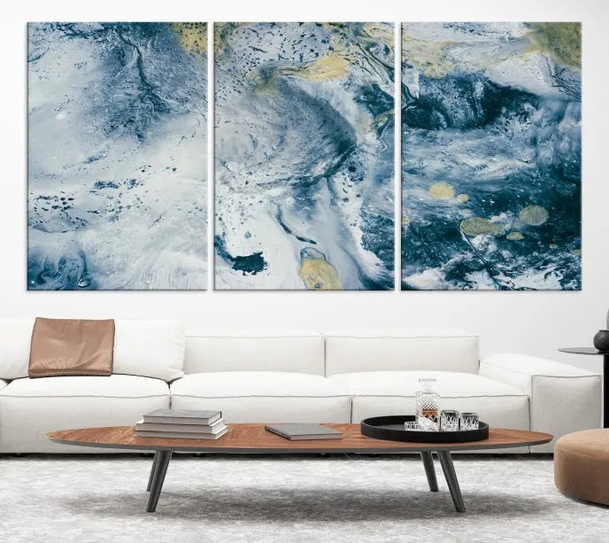 A modern living room features an Abstract Canvas Print as triptych artwork on the wall, elegantly showcased for enduring vibrancy.